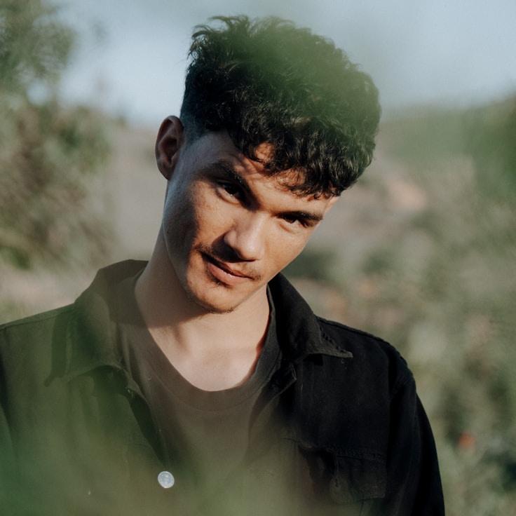 Aarav Shah, Lead Design Curator at TranquilHarborAssociation, reviewing corporate floral arrangements